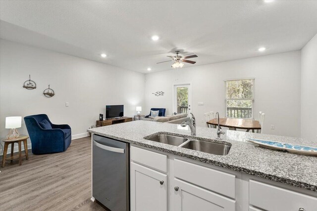 kitchen featuring white cabinetry, light wood-type flooring, sink, dishwasher, and ceiling fan