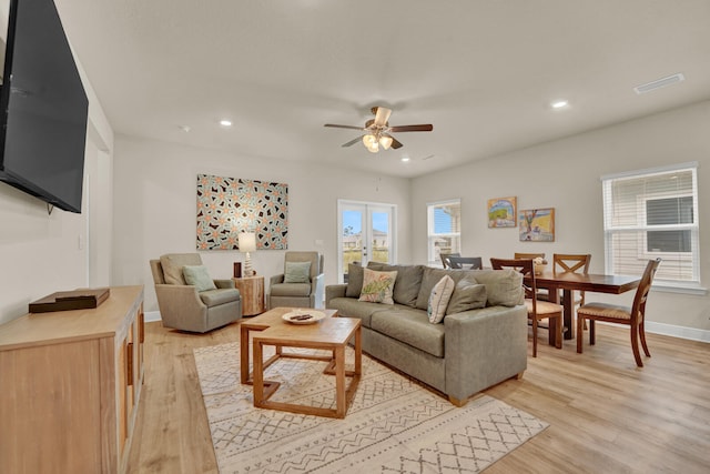 living room featuring ceiling fan and light hardwood / wood-style floors