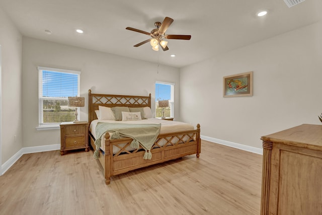 bedroom with light hardwood / wood-style floors and ceiling fan