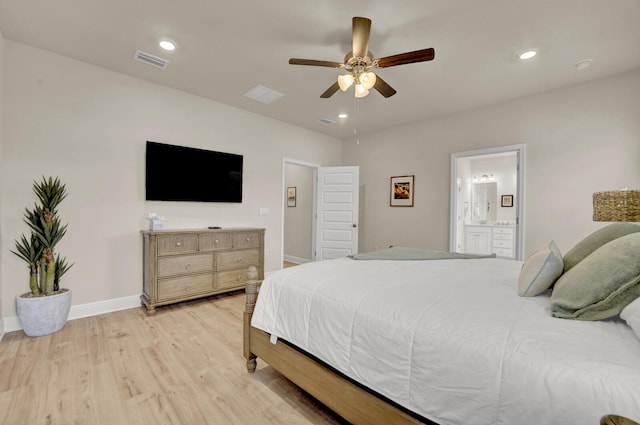 bedroom with light hardwood / wood-style floors, ceiling fan, and ensuite bath