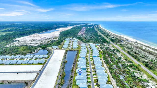 drone / aerial view with a beach view and a water view