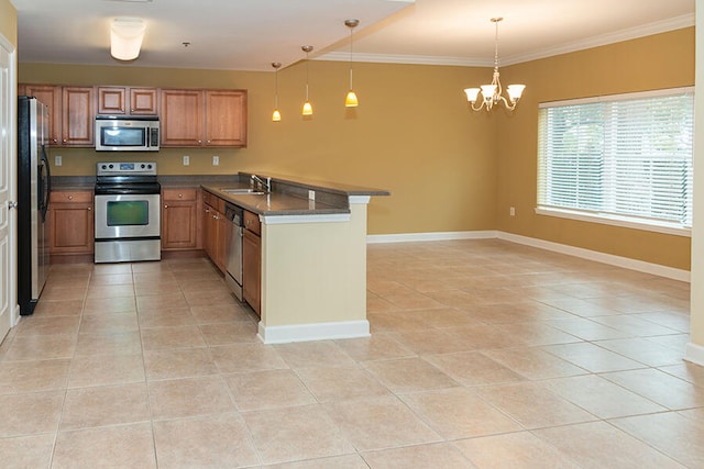 kitchen featuring kitchen peninsula, crown molding, pendant lighting, a chandelier, and appliances with stainless steel finishes