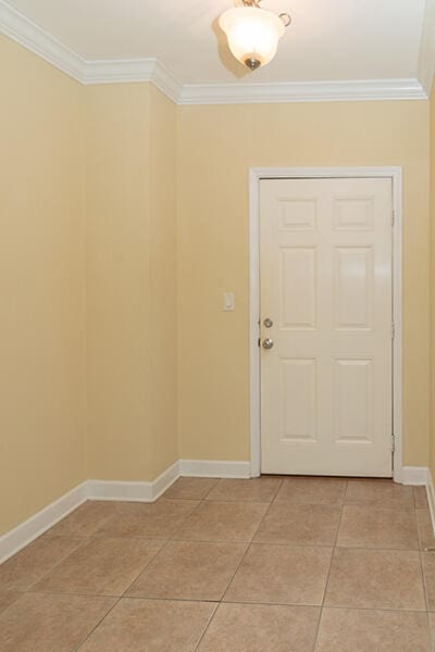 entryway featuring crown molding and light tile patterned flooring