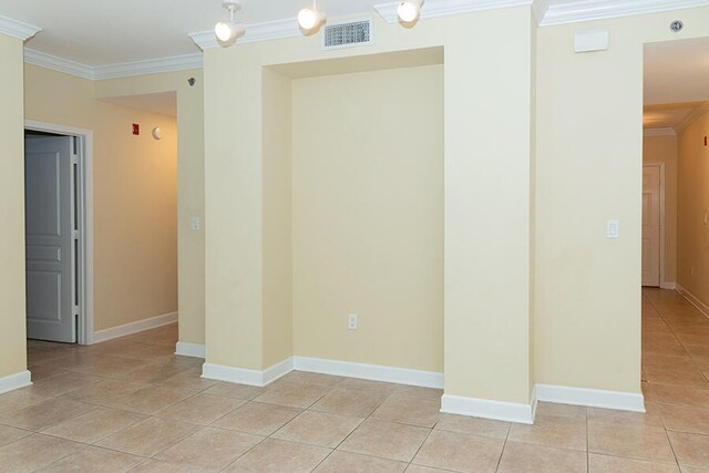 tiled spare room with ornamental molding