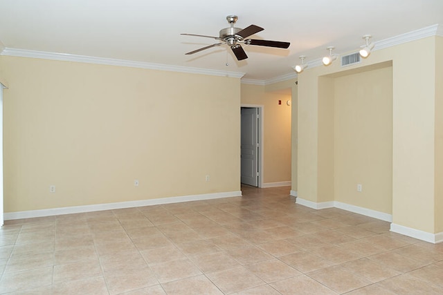 spare room featuring crown molding, light tile patterned flooring, and ceiling fan