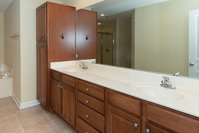 bathroom featuring vanity, plus walk in shower, and tile patterned floors