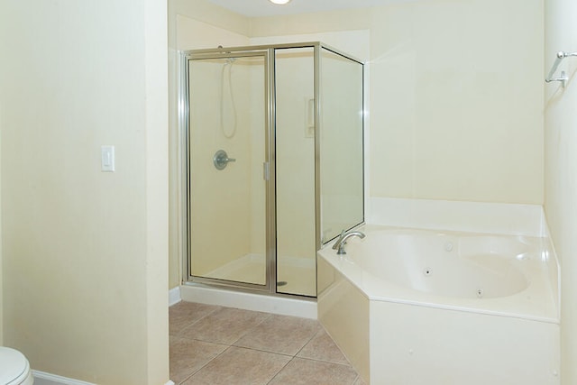 bathroom featuring tile patterned floors, plus walk in shower, and toilet