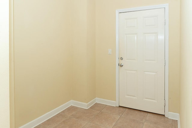 doorway with light tile patterned floors