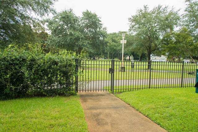 view of gate featuring a lawn