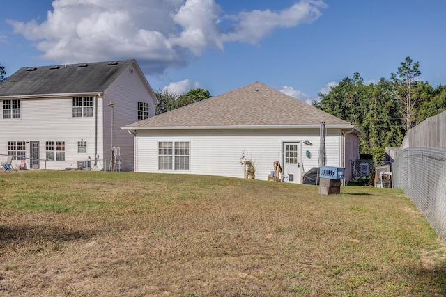 back of house with a lawn