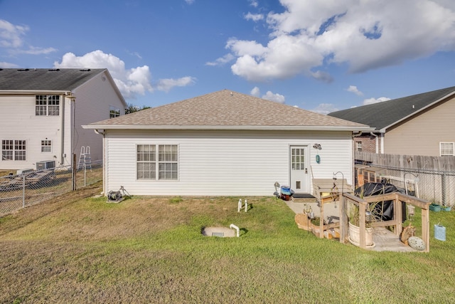 rear view of house with a yard and a patio