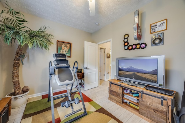 exercise room with a textured ceiling