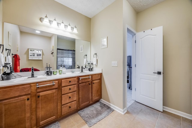 bathroom with vanity, a shower, a textured ceiling, and tile patterned flooring