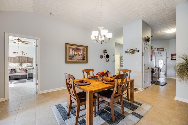 tiled dining room featuring a textured ceiling, lofted ceiling, and ceiling fan with notable chandelier