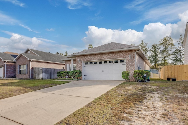 view of front of property featuring brick siding, concrete driveway, an attached garage, a front yard, and fence