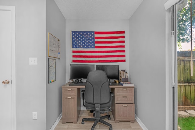 office area with plenty of natural light and a textured ceiling