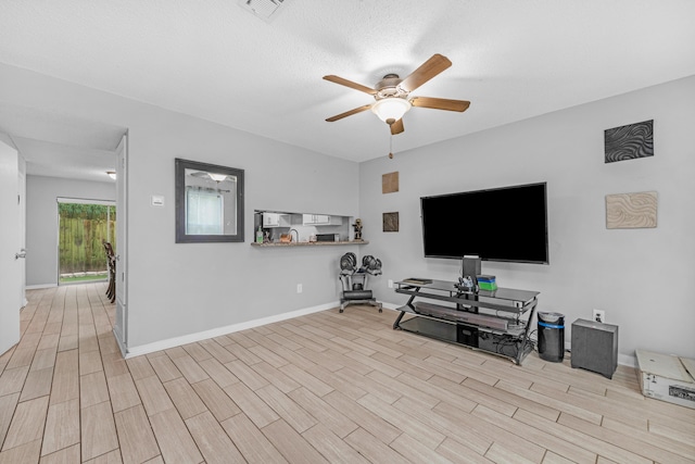 living room featuring light wood-type flooring and ceiling fan