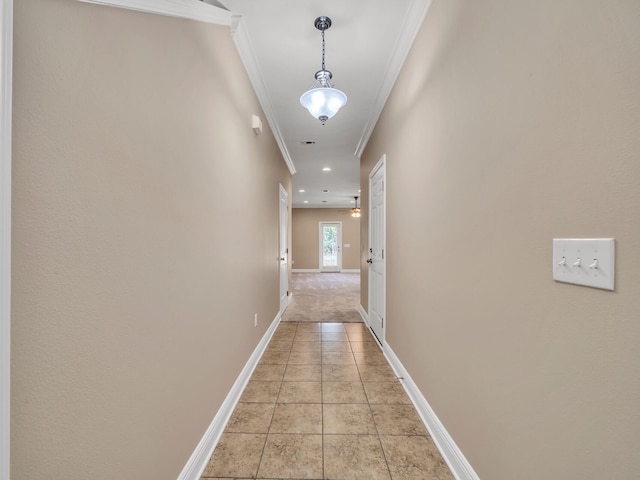 corridor with ornamental molding and light tile patterned floors