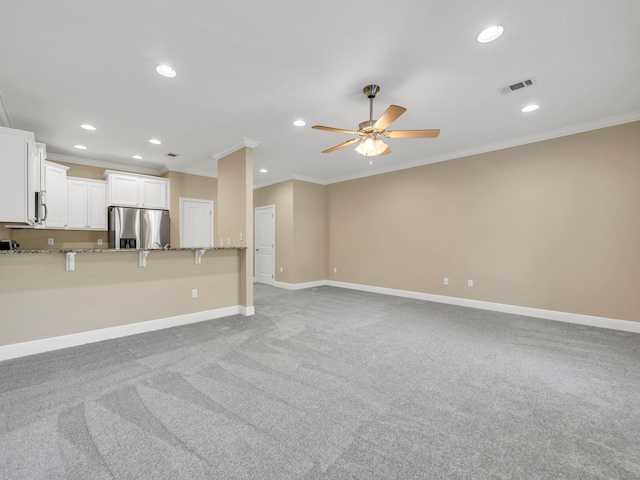 unfurnished living room featuring crown molding, light colored carpet, and ceiling fan