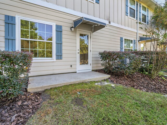 entrance to property featuring a lawn