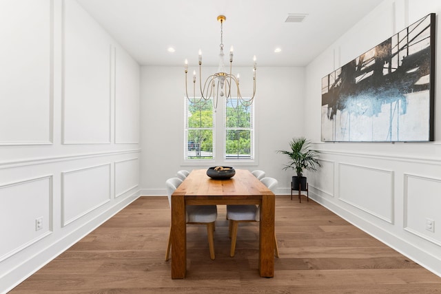 dining room featuring light hardwood / wood-style floors and a chandelier