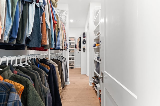 spacious closet with light hardwood / wood-style floors