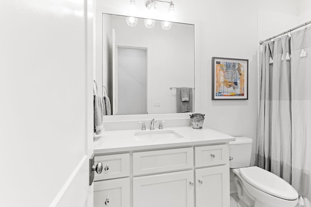 bathroom featuring toilet, a shower with curtain, and vanity