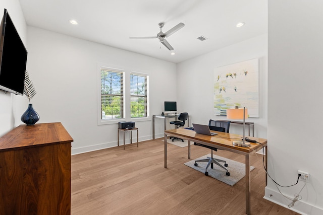 office with light hardwood / wood-style floors and ceiling fan