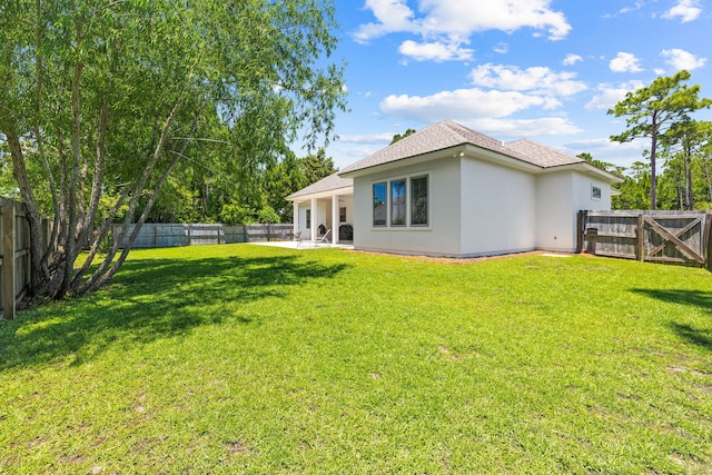 back of property with a lawn