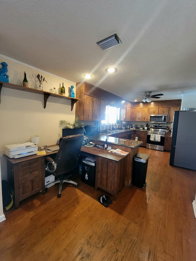 office space featuring dark wood-type flooring, ceiling fan, a textured ceiling, and sink