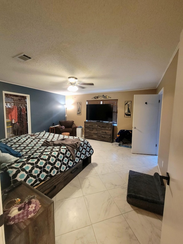 bedroom with a closet, a walk in closet, crown molding, a textured ceiling, and ceiling fan