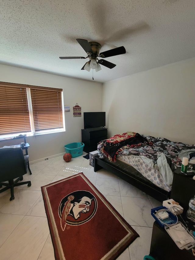 bedroom with ceiling fan, a textured ceiling, and light tile patterned floors