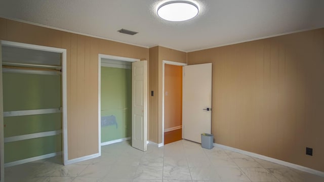 1097 Bob Mccaskill Dr, Defuniak Springs, FL 32433 - unfurnished bedroom with light marble finish floors, crown molding, wood walls, and baseboards
