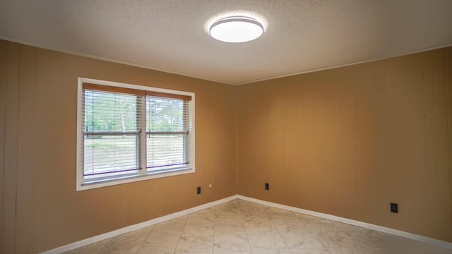 1097 Bob Mccaskill Dr, Defuniak Springs, FL 32433 - empty room featuring light marble finish flooring, a textured ceiling, and baseboards