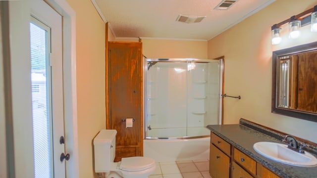 1097 Bob Mccaskill Dr, Defuniak Springs, FL 32433 - full bath featuring crown molding, toilet, vanity, enclosed tub / shower combo, and tile patterned flooring