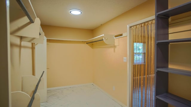 1097 Bob Mccaskill Dr, Defuniak Springs, FL 32433 - walk in closet featuring marble look tile flooring