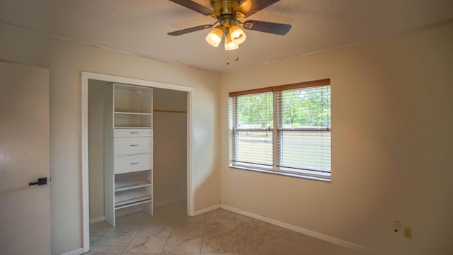 1097 Bob Mccaskill Dr, Defuniak Springs, FL 32433 - unfurnished bedroom with baseboards, a closet, light marble finish floors, ceiling fan, and ornamental molding