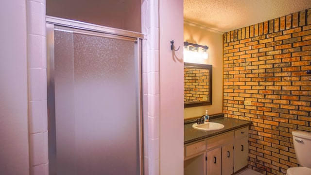 1097 Bob Mccaskill Dr, Defuniak Springs, FL 32433 - full bathroom with brick wall, a textured ceiling, a stall shower, toilet, and vanity