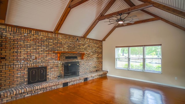1097 Bob Mccaskill Dr, Defuniak Springs, FL 32433 - unfurnished living room with a brick fireplace, wood finished floors, a ceiling fan, baseboards, and beamed ceiling
