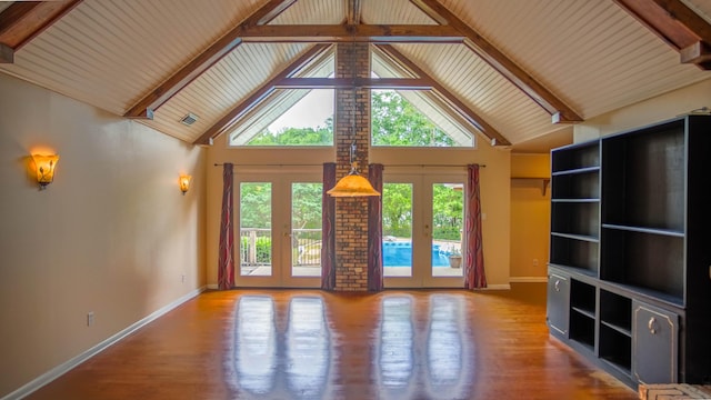 1097 Bob Mccaskill Dr, Defuniak Springs, FL 32433 - unfurnished living room with french doors, baseboards, wood finished floors, high vaulted ceiling, and beam ceiling