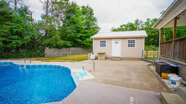 1097 Bob Mccaskill Dr, Defuniak Springs, FL 32433 - view of swimming pool featuring an outdoor structure, a patio area, and fence