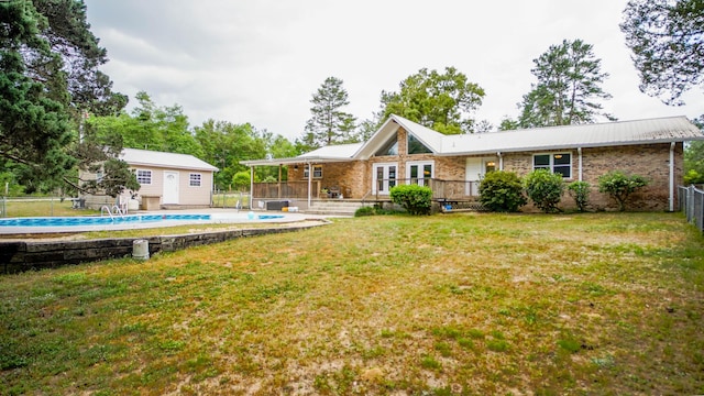 1097 Bob Mccaskill Dr, Defuniak Springs, FL 32433 - rear view of property with a wooden deck, brick siding, an outdoor structure, and metal roof