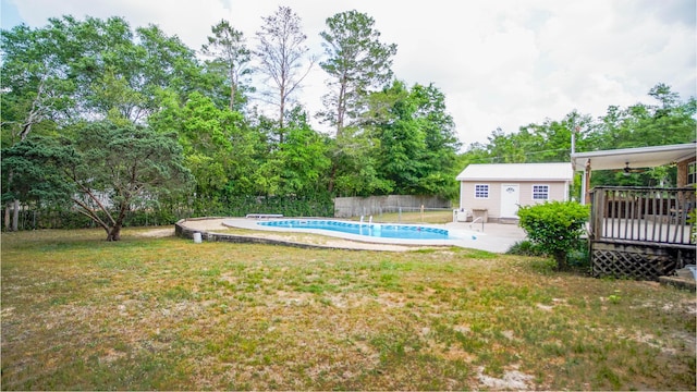 1097 Bob Mccaskill Dr, Defuniak Springs, FL 32433 - view of swimming pool featuring an outbuilding, a wooden deck, a ceiling fan, and view of wooded area