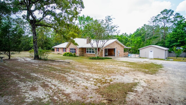 1097 Bob Mccaskill Dr, Defuniak Springs, FL 32433 - ranch-style house with driveway, a garage, and a front yard