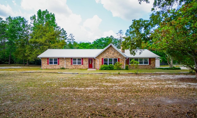 1097 Bob Mccaskill Dr, Defuniak Springs, FL 32433 - ranch-style house featuring a front lawn and metal roof