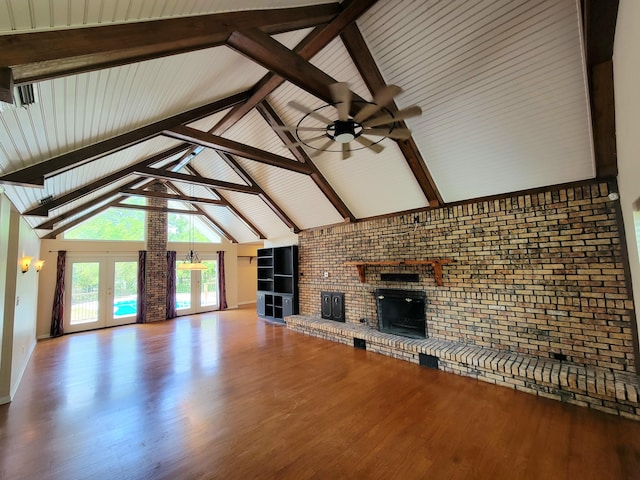 1097 Bob Mccaskill Dr, Defuniak Springs, FL 32433 - unfurnished living room with a brick fireplace, ceiling fan, wood finished floors, brick wall, and beamed ceiling