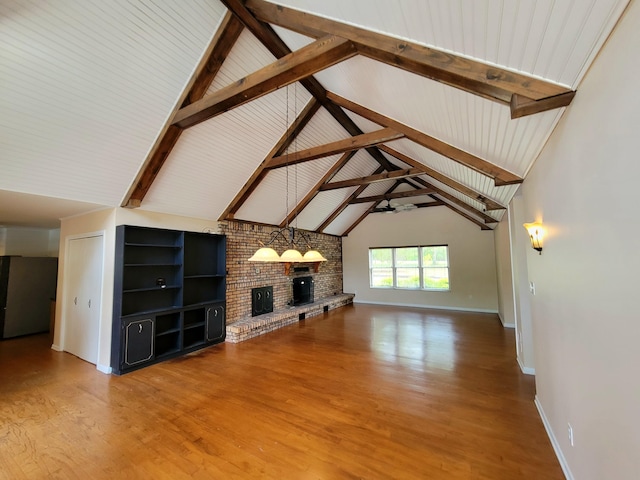 1097 Bob Mccaskill Dr, Defuniak Springs, FL 32433 - unfurnished living room with a brick fireplace, wood finished floors, baseboards, high vaulted ceiling, and beam ceiling