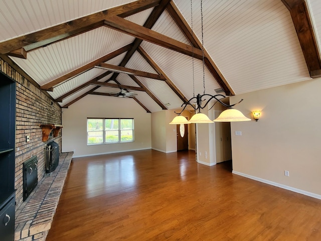 1097 Bob Mccaskill Dr, Defuniak Springs, FL 32433 - unfurnished living room with a brick fireplace, baseboards, ceiling fan, wood finished floors, and vaulted ceiling