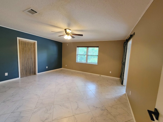 1097 Bob Mccaskill Dr, Defuniak Springs, FL 32433 - empty room with ceiling fan, a barn door, a textured ceiling, light marble finish floors, and baseboards