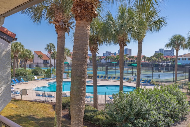 view of pool featuring tennis court